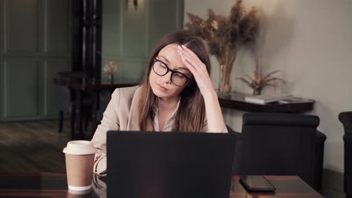 Unhappy Tired Overworked Woman Suffering From Strong Migraine in Workplace