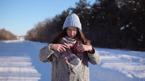 Young Pretty Woman Walking in the Winter Park