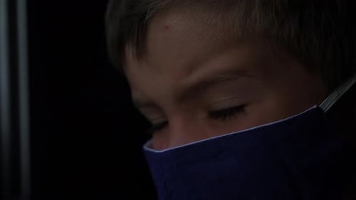 Little Passenger Wearing Facemask Looking at Train Window. Child-boy Looks at Sun. Six Years Old Boy