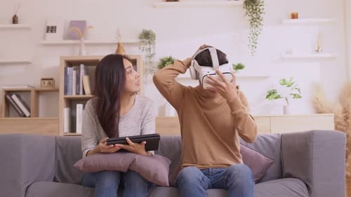 Couple Experiencing Virtual Reality at Home Together