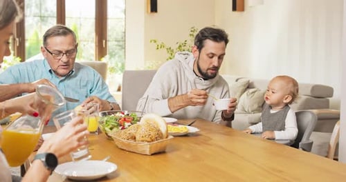 Family eating together during a sunny day indoors