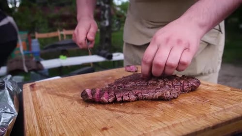 Slicing Tender Cooked Steak on Cutting Board