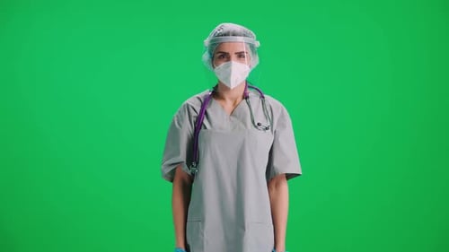 Portrait of Young Female Doctor in Protective Gear and Medical Mask Woman Looks at the Camera and