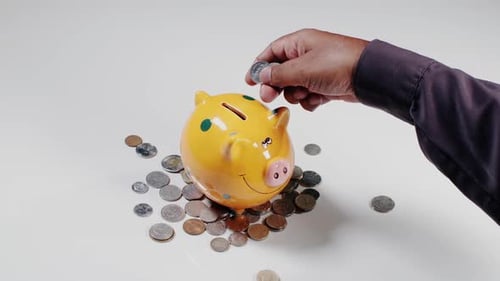 Depositing Coins Into Piggy Bank