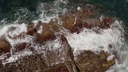 Ocean Waves Breaking Onto Rocky Shore