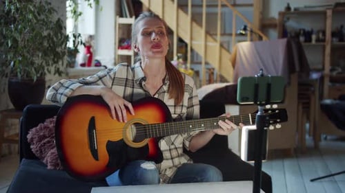 Woman Explains Guitar Chords for Her Online Tutorial