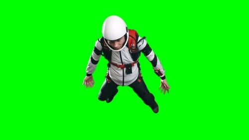 Skydiver in White Jumpsuit Falls on Green Screen