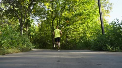 Slow Motion Man Jogging in Summer Park