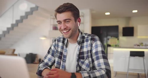 Smiling Couple Video Chatting on Laptop at Home