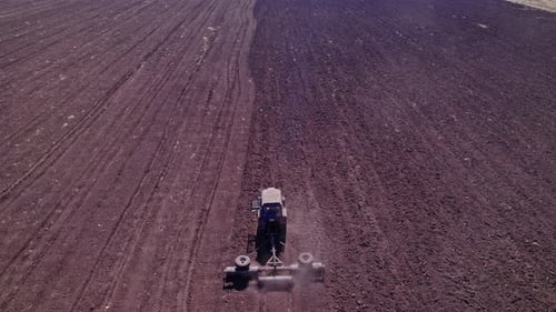 Tractor Tilling Center of Farm Field in the Fall