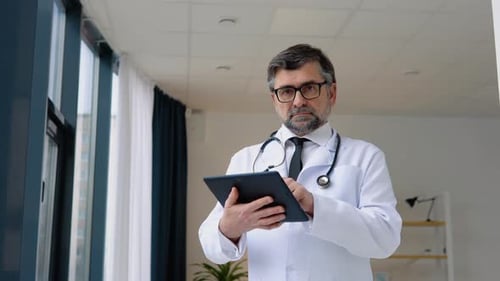 Senior Doctor 50s Works in Tablet