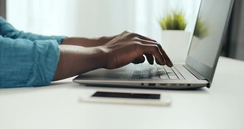 Hands Typing on Laptop Computer Keyboard Indoors