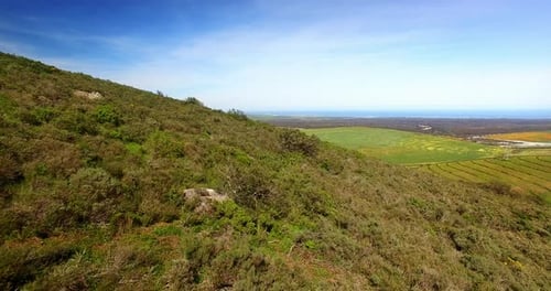 Aerial view of a dirt road winding through mountainous terrain