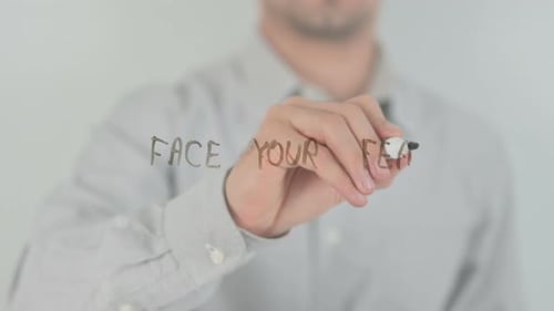 Man Writes 'Face Your Fears' on Glass Surface