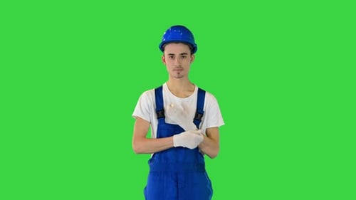 Construction Worker Wearing Protective Gloves on a Green Screen Chroma Key