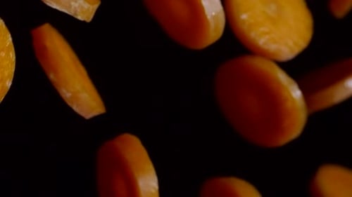 Carrot Pieces over Black Background