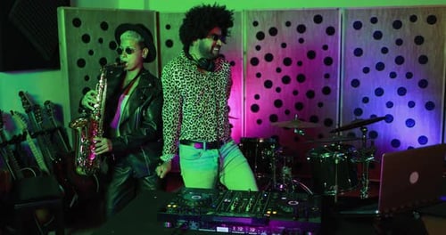 Dj and female saxophone musician playing music inside boutique recording studio