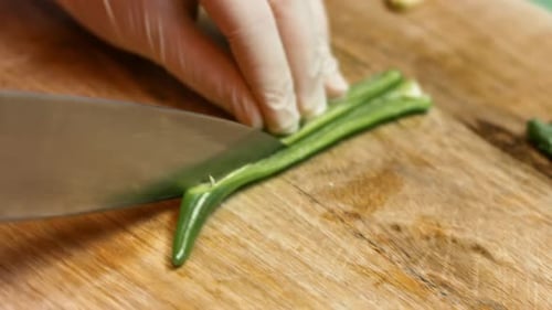 Dicing Green Pepper on Wooden Cutting Board