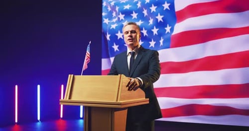 Man Giving Speech at Podium with American Flag