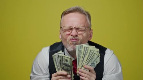Adult licking large stacks of United States money