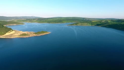 Lake view surrounded by lush forests.