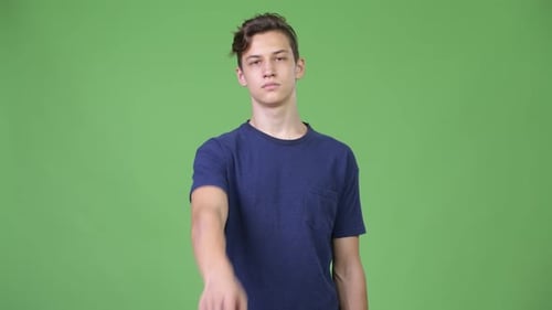 Young Handsome Teenage Boy Pointing To Camera