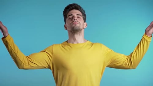 Calm student guy or businessman relaxing, meditating. Handsome european man calms down