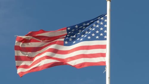 American Flag Waving on Flagpole on a Clear Day