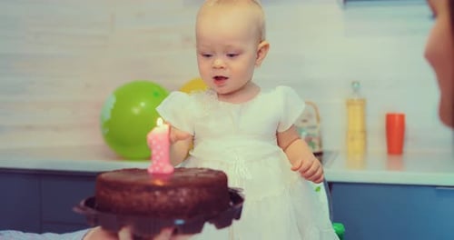Infant Celebrates First Birthday with Cake Indoors