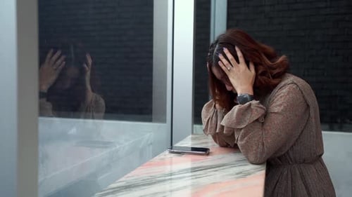 Stressed Woman Standing With Hands on Head