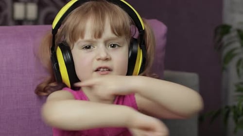 Enthusiastic Child Dancing with Headphones On