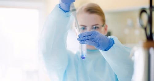 Scientist Carefully Adding Liquid to Test Tube