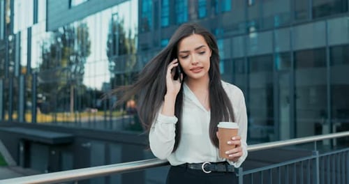 Stylish Woman Talking on Phone Outside Office Building