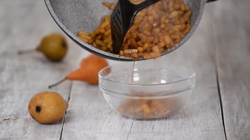 Putting Stewed Pears with Cinnamon Into Bowl