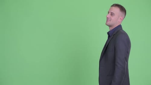 Profile View of Happy Handsome Businessman in Suit Smiling