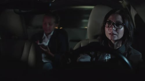 Woman and Little Girl Drive in Car at Night.