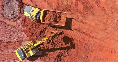 Top Aerial View Excavator Truck are Loading Soil a Dump Truck