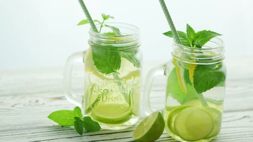 Refreshing Citrus Beverage with Mint and Straws