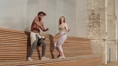 Stylish Young Couple Dancing on an Urban Stage