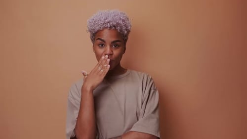 Woman Posing with Fingers at Lips in Studio