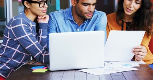 Young Adults Collaborating on a Project in Office