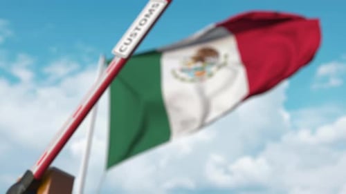 Mexican Customs Barrier Opening with National Flag Background