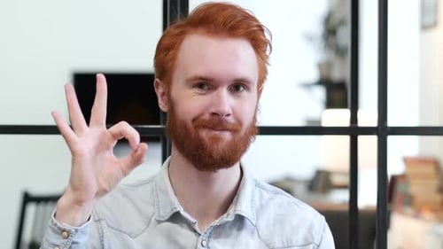 Young Adult Gives Okay Sign and Smiles