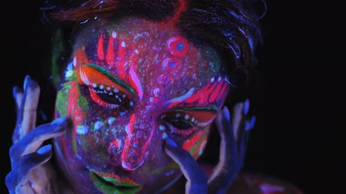 Closeup of a Girl's Face with an Ultraviolet Pattern in Neon Light