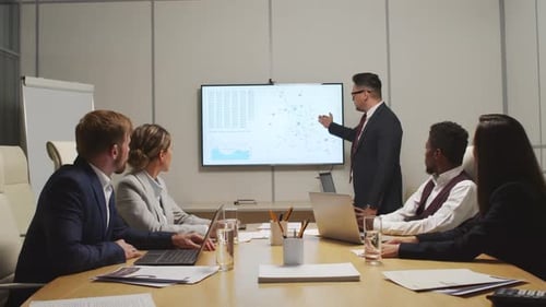 Business People Presenting Data at Meeting