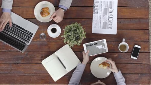 Business People Using Gadgets at Breakfast