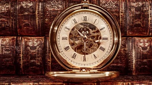 Gold Pocket Watch on Old Books