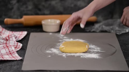 Rolling Dough with a Wooden Rolling Pin