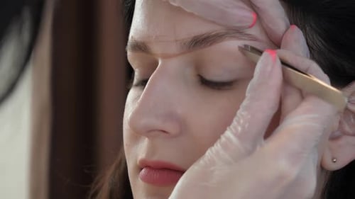 Woman getting eyebrow shaping treatment
