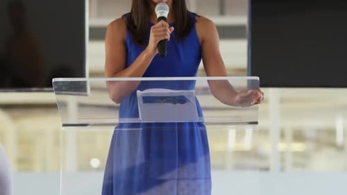 Woman Speaking at Podium in Corporate Setting